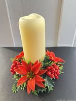 Ivory pillar candle seated in festive wreath