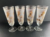 Front view of four Libbey pinecone frosted Pilsner glasses