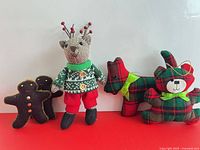 Group shot showing all five plush ornaments