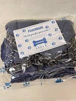 Coat in original plastic packaging with Poochbark thank-you card