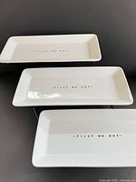 Top-down view of three china plates on stand showing text