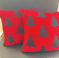 Front view of both red pillows with tree pattern