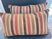 Two matching striped lumbar pillows front view