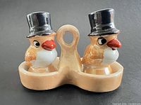 Front view of both bird shakers seated in holder