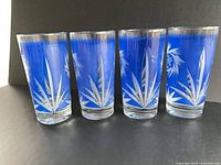 Front view of all four cobalt cut-to-clear glasses