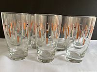 Front view of several Ocean highball glasses showing pattern
