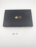 Closed black presentation box with RCM gold logos