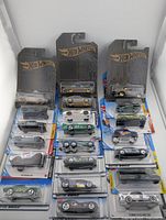 Full lot of 21 carded Hot Wheels cars displayed upright