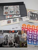 Overview of stamps and postcards including Beatles album stamps, memorabilia miniature sheet, Paul McCartney miniature sheet and USPS Lennon pane