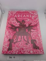 Front view of sealed Arcane art book