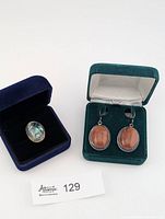 Ring and earrings in individual boxes side by side