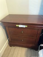 Front view of one Durham Furniture side table showing two drawers and brass pulls