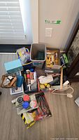 Overall lot showing bins with assorted tools, parts cases, extension cord, stud finder and hardware