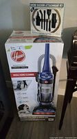 Front of sealed Hoover WindTunnel Complete Canister vacuum box beside micro attachment kit