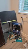 Overall view showing music stand, boxed GS536B stand, steel stand, guitar straps bin