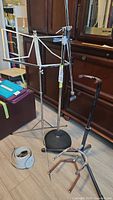Group shot of guitar stand, microphone stand, sheet music stand, guitar straps