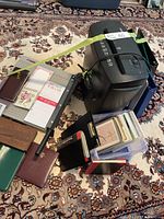 Lot overview showing shredder, paper cutter, books, bin of cards