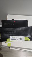 Two black Shure vinyl pouches with embossed logo