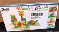 Front of sealed box showing brand, product name and sample assembled animal puzzles