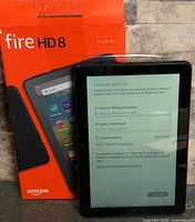 Front of Fire HD 8 tablet beside retail box showing screen