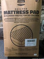 Front of boxed Utopia Bedding Quilted Mattress Pad