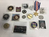 Overall view of the fifteen coins, token and medal