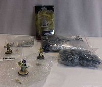 Group shot showing sealed Otyugh package, three painted figures, and bags of parts
