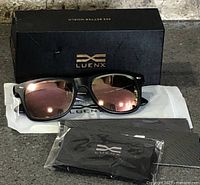 Full set showing sunglasses, pouch, cloth and box
