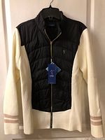 Front view of cream and black LPGA jacket with tags attached