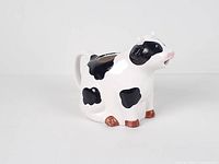 Front left view of cow creamer jug showing color and form