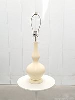 Full view of ceramic gourd-shaped lamp on round table