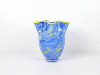 Full front view of the blue and yellow ruffled art glass vase