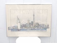 Full view of framed art print showing cityscape and frame