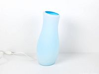 Full view of blue glass lamp with cord and switch