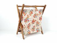 Full view of folded wooden frame with floral fabric pouch