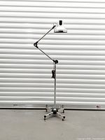 Full view of adjustable HKL floor lamp on casters
