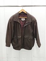 Full view of jacket front hanging, showing overall style, color, pockets and elastic hem