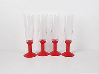 Four champagne flutes standing in a row, full view