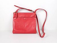 Front view of red leather Fossil crossbody bag