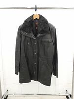 Full front view of the black leather jacket hanging on rack