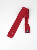 Full view of red knit tie showing overall length and form