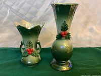 Front view of both iridescent green ceramic vases showing poinsettia holly decoration