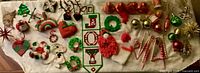 Full lot overview of all vintage ornaments laid out on cloth