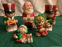 All five rubber pieces grouped on green cloth