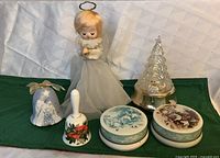 Group shot showing all six items: angel, musical tree, two bells, two tins
