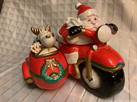 Front view of Santa motorcycle cookie jar showing both compartments