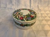 Closed round Mikasa Christmas Bouquet trinket box showing top decoration
