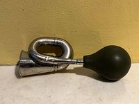 Overall view of antique Condor bulb horn showing metal body and rubber bulb