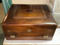 Closed walnut cutlery chest front view