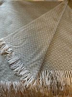 Full throw blanket showing both sides and fringe